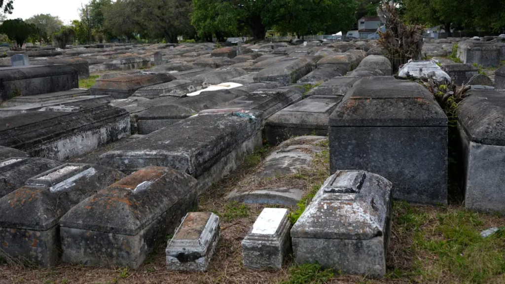 QR code stickers appear on the grave